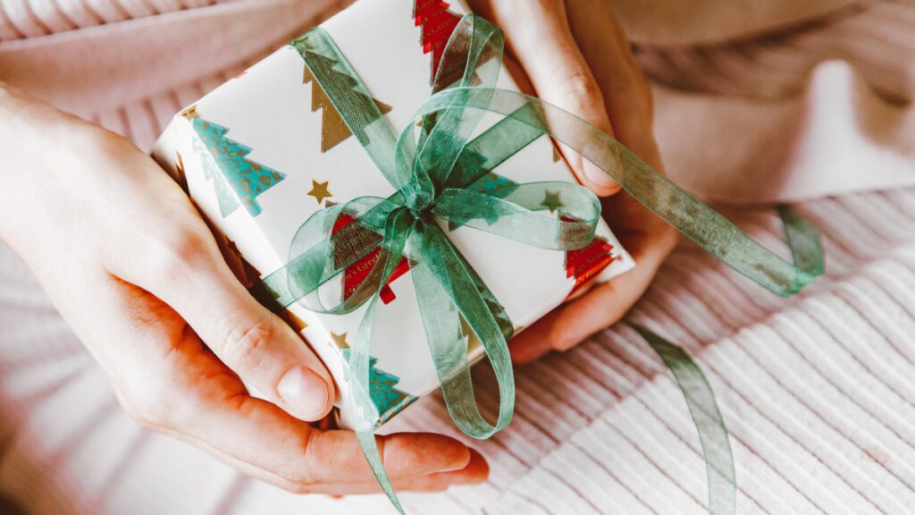 Best Gift for Everyone_ A Person Holding a Gift with Green Ribbon